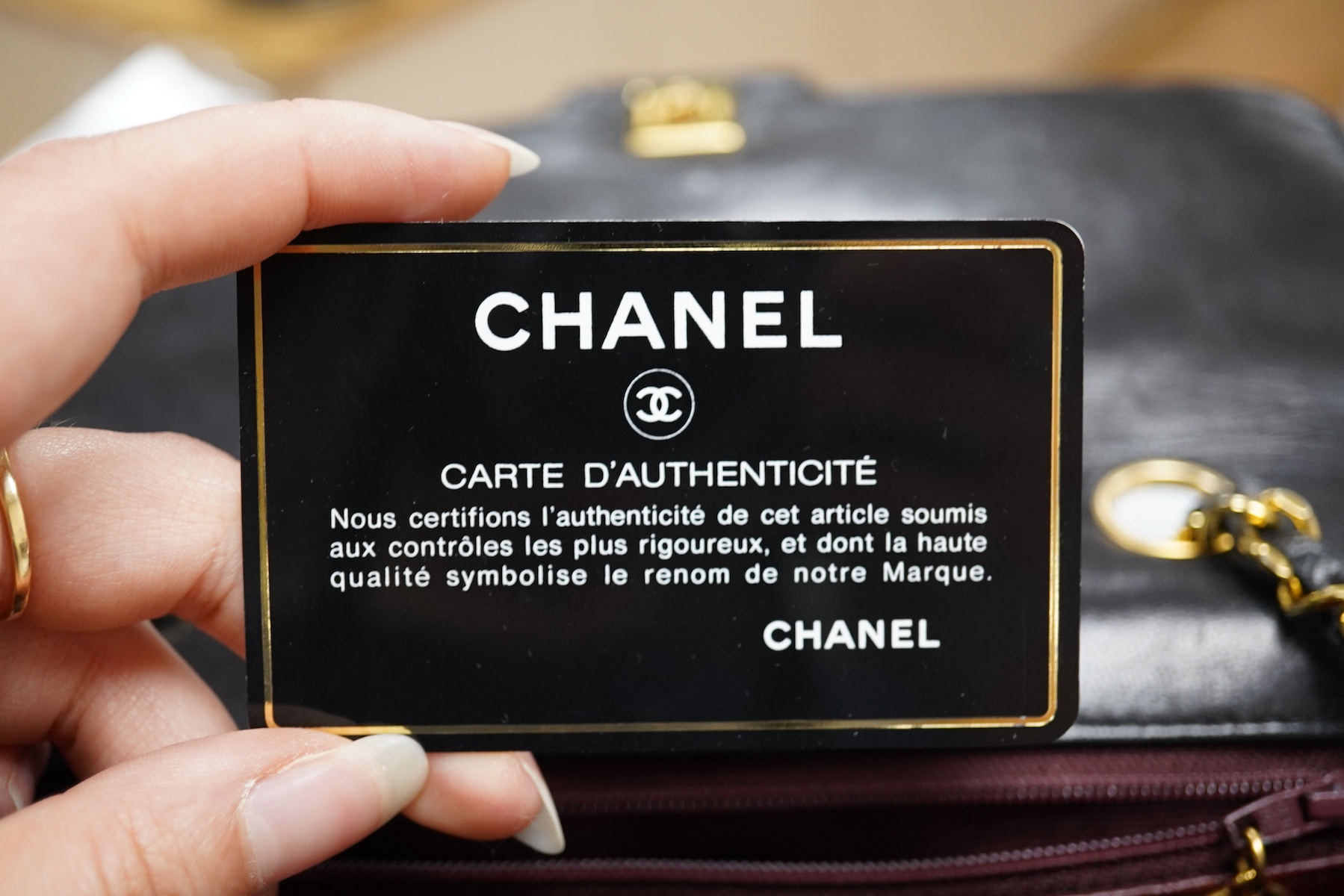 A late 1980’s Chanel black leather Diana shoulder bag with original dust cover and bag, Chanel authenticity card numbered 1944645, interior date code rubbed, 23cm wide, Provenance: Purchased by the vendor, 26 Old Bond St